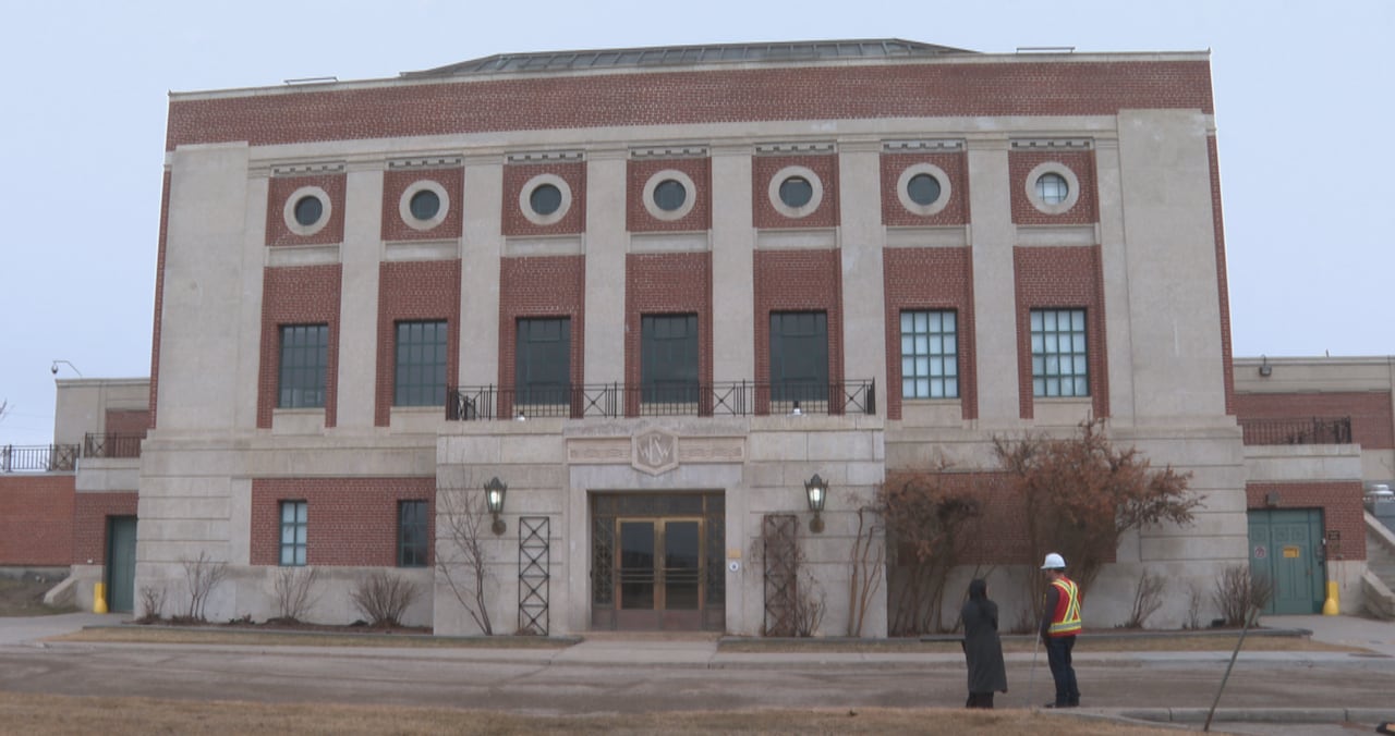 The exterior of the filtration building at the Glenmore Water Treatment Plant. It's made of red brick and stone, and there are circular porthole windows near the top.