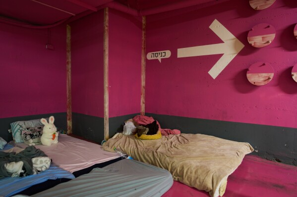 A child's stuffed rabbit sits on one of the mattresses spread across an underground parking garage where people spend the night as a precaution against possible Iranian missile attacks in Tel Aviv, Israel, Saturday, March 14, 2026. (AP Photo/Oded Balilty)