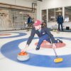 Ted Hallock delivers a rock during a curling game at the Potomac Curling Club in Laurel, Md. Curling clubs often see a boost in interest following the Winter Olympics.
