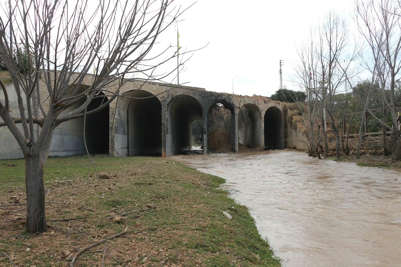 A damaged bridge sits on top of a river.