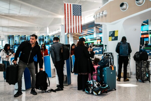 People arrive to queue in a TSA security line at Terminal A of Newark Liberty International Airport (EWR) in Newark, N.J., Tuesday, March 24, 2026. (AP Photo/Eduardo Munoz Alvarez)