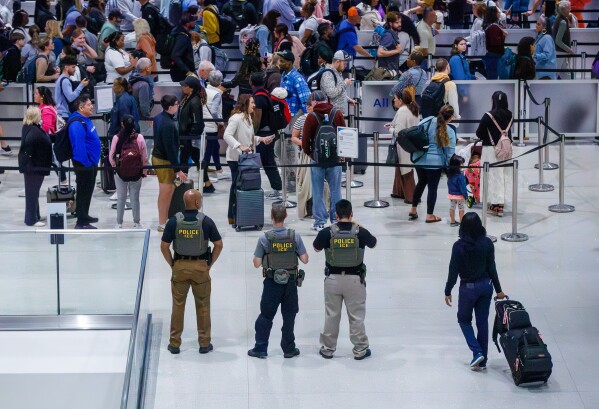 U.S. Immigration and Customs Enforcement (ICE) agents patrol Louis Armstrong International Airport in Kenner, La., Monday, March 23, 2026. (David Grunfeld/The New Orleans Advocate via AP)
