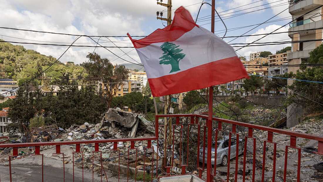 The Lebanese flag is waved amid the rubble of a Lebanese Civil Defence post destroyed in an IDF airstrike in Nabatiyeh, Lebanon, on March 24, 2026.