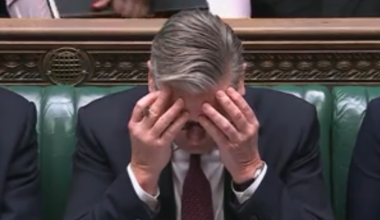 Keir Starmer speaking at Prime Ministers Questions in the UK Parliament, addressing key issues with government officials.