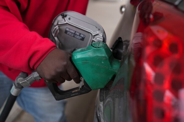 Dave Thomas purchases gasoline at a station March 24, 2026, in Chicago. (AP Photo/Erin Hooley, File)