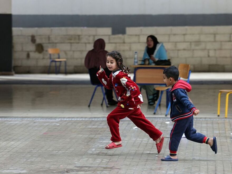 Displaced Lebanese children play in the playground of a public school that has been converted into a shelter in the town of Dekwaneh, north of Beirut on March 25, 2026.