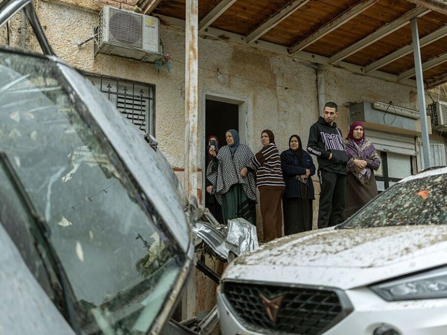 Arab-Israeli residents surveys the damage following a projectile strike in the Arab-Israeli city of Kfar Qassem on March 26, 2026.