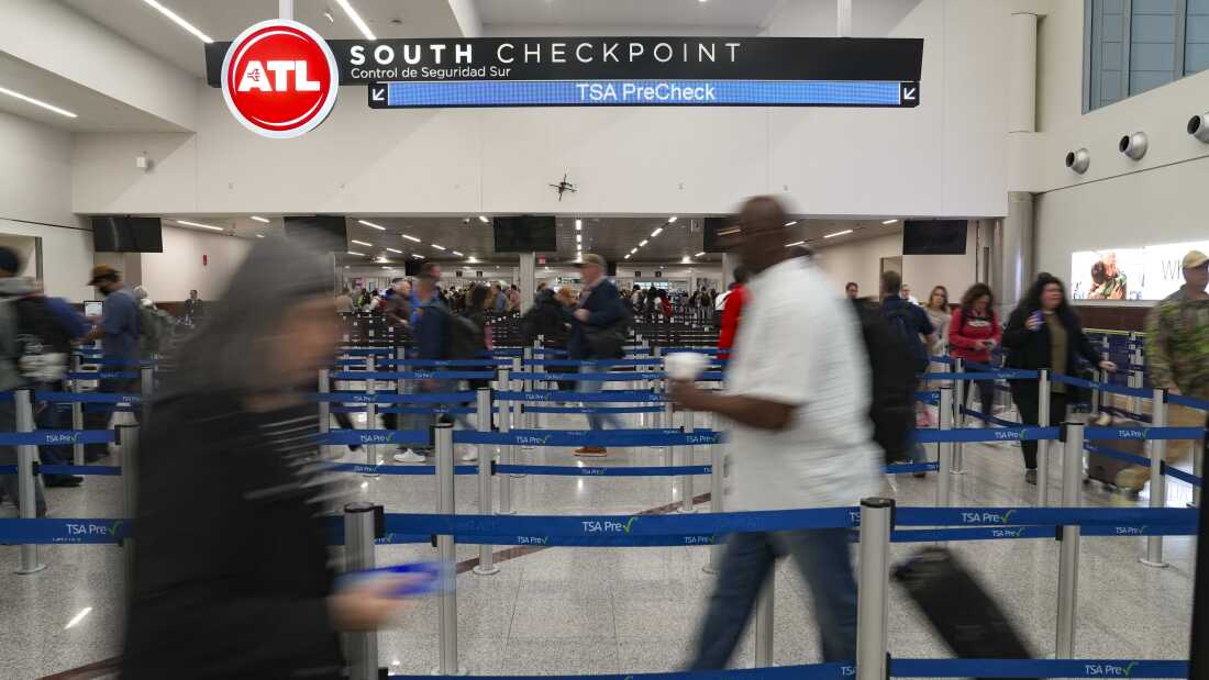 Travelers move through the South TSA checkpoint at Atlanta Hartsfield-Jackson International Airport in Atlanta, Georgia.