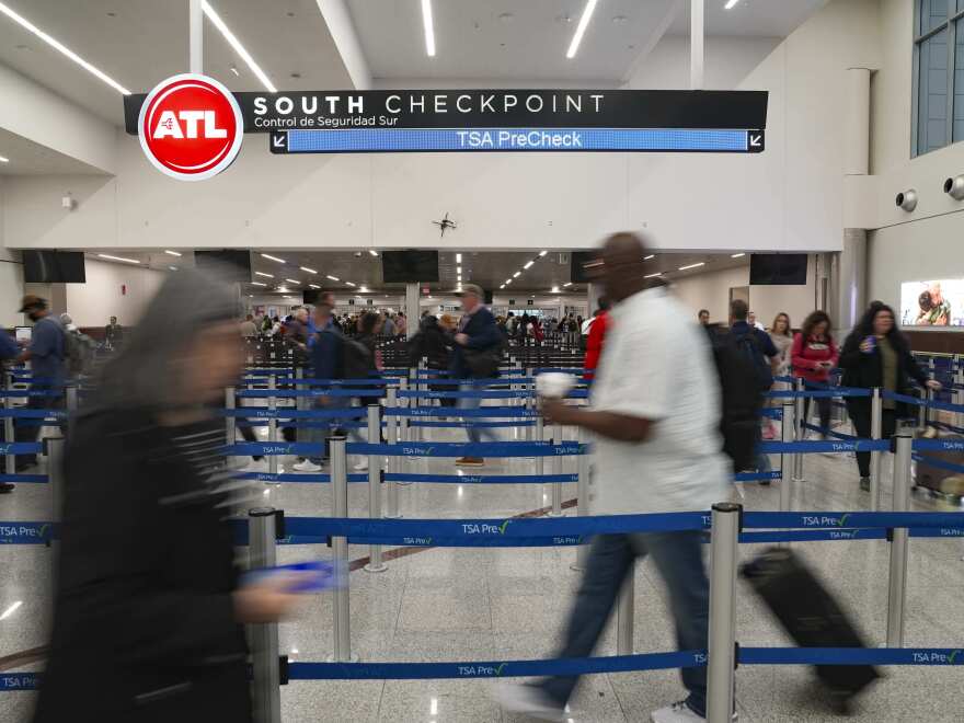 Travelers move through the South TSA checkpoint at Atlanta Hartsfield-Jackson International Airport on March 25, 2026, in Atlanta, Georgia.