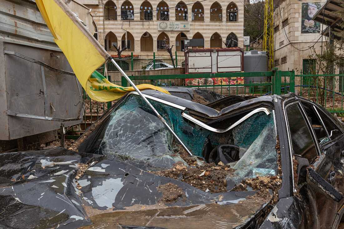 A Hezbollah flag is seen in a destroyed car after an Israeli airstrike in Nabi Chit (Al-Nabi Shayth), Lebanon, on March 26, 2026.