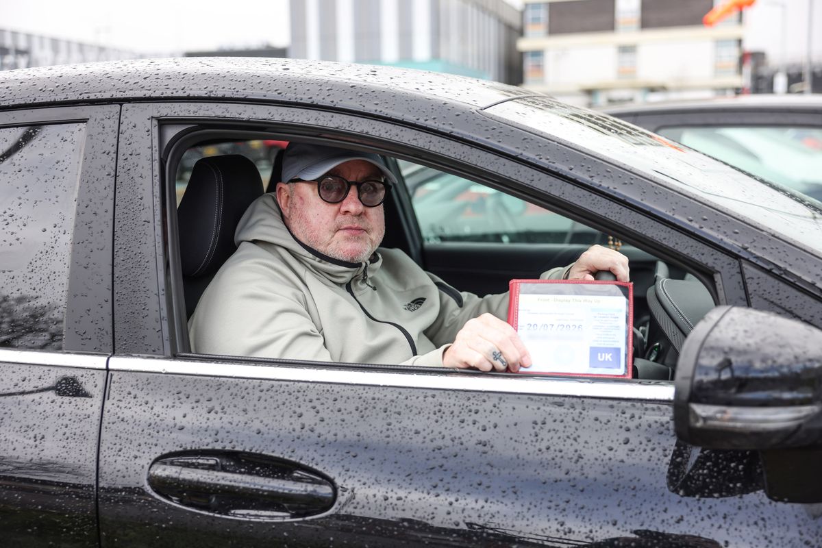 Stephen O'Rourke with his blue badge near where he was parked in Aintree University Hospital car park