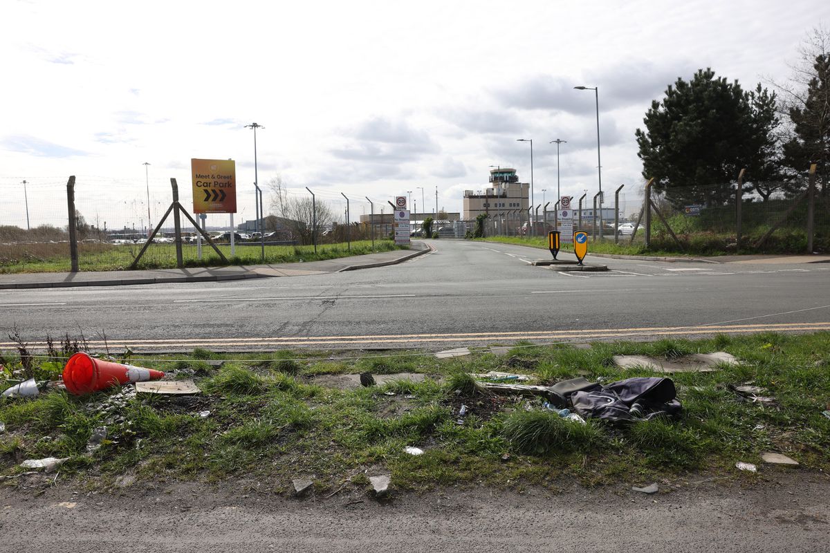 The grass verge on Hale Road people use to avoid airport parking charges in Speke, facing the new signs for Aviation Avenue and the meet and greet car park