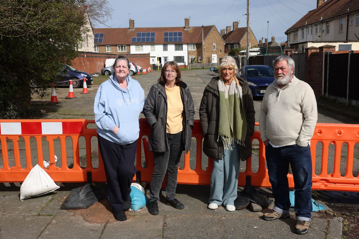 Residents at the barricade constructed by locals which blocks access to Dam Wood Road from Hale Road. The taped off on the area on the left was referred to by one resident as "the Speke toilet" 