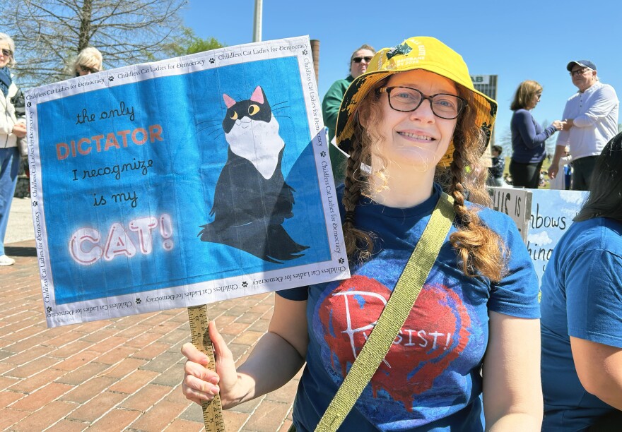 Elementary school teacher Cooper Chunn holds a sign during the Birmingham No Kings protest
