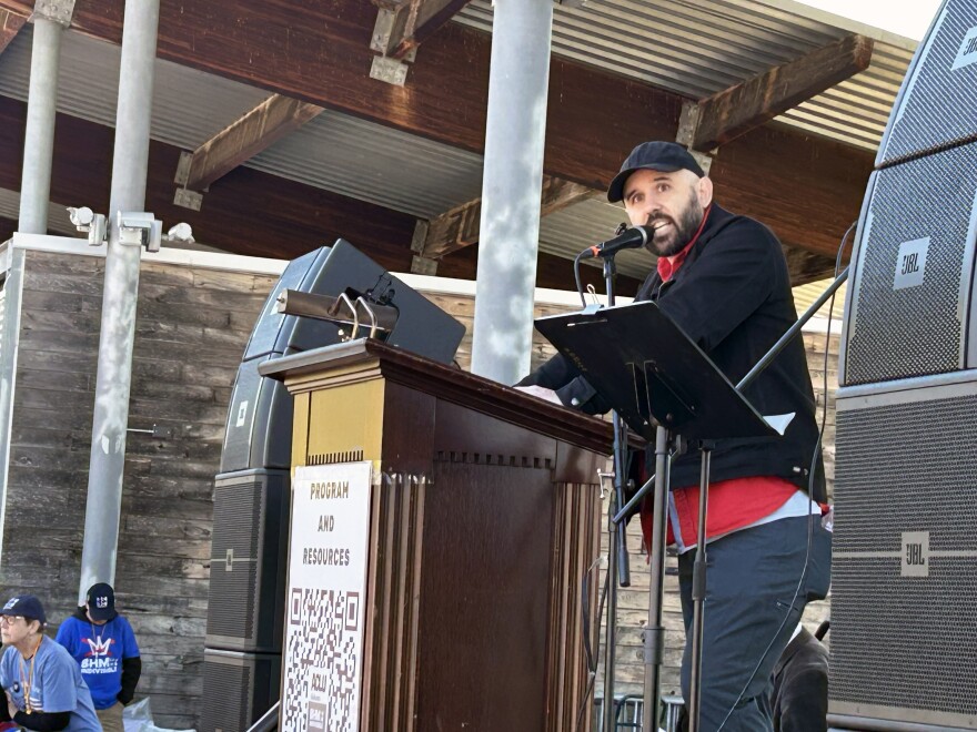 Luis Robledo, an organizer with Jobs to Move America, speaks to the crowd at the No Kings rally