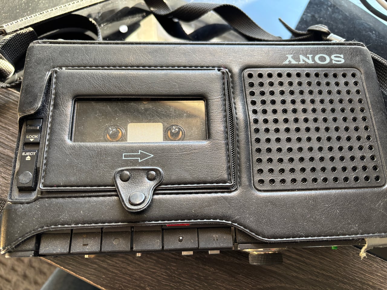A cassette recorder bound in a leather case.