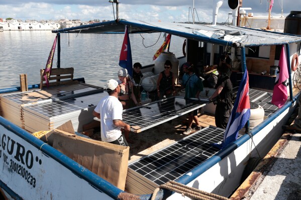 Activists from the vessel Maguro, that arrived from Mexico, unload solar panels and other humanitarian aid from the "Nuestra America," or Our America convoy, at the port in Havana Bay, Cuba, Tuesday, March 24, 2026. (Jorge Luis Banos/IPS via AP, Pool)
