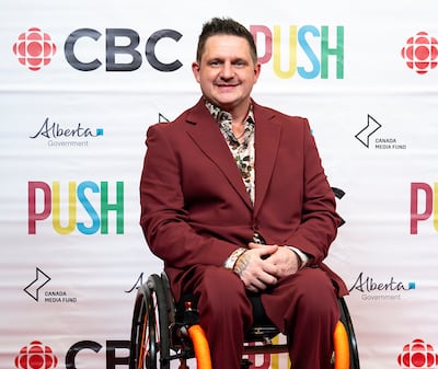 man in front of cbc push signs