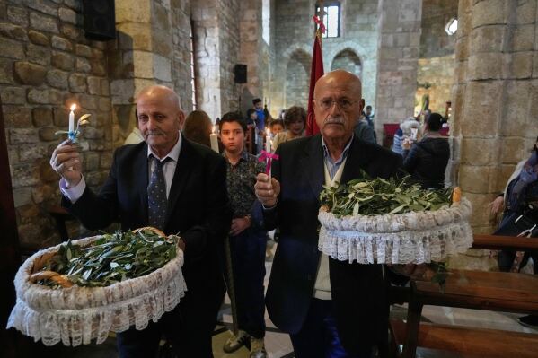 Worshipers attend Palm Sunday Mass procession at Saint Thomas Cathedral, in the southern port city of Tyre, south Lebanon, Sunday, March 29, 2026. (AP Photo/Hussein Malla)