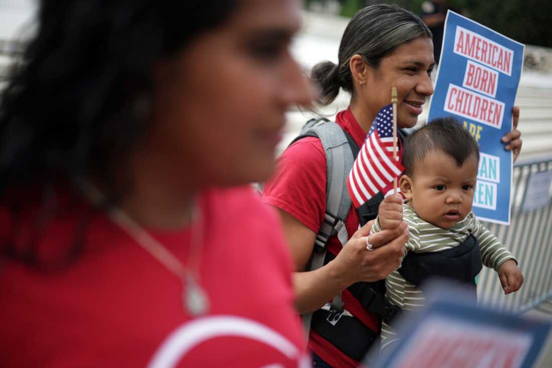 This photo shows Olga Urbina carrying her baby Ares Webster from another angle at the same protest in front of the Supreme Court on May 15, 2025. 