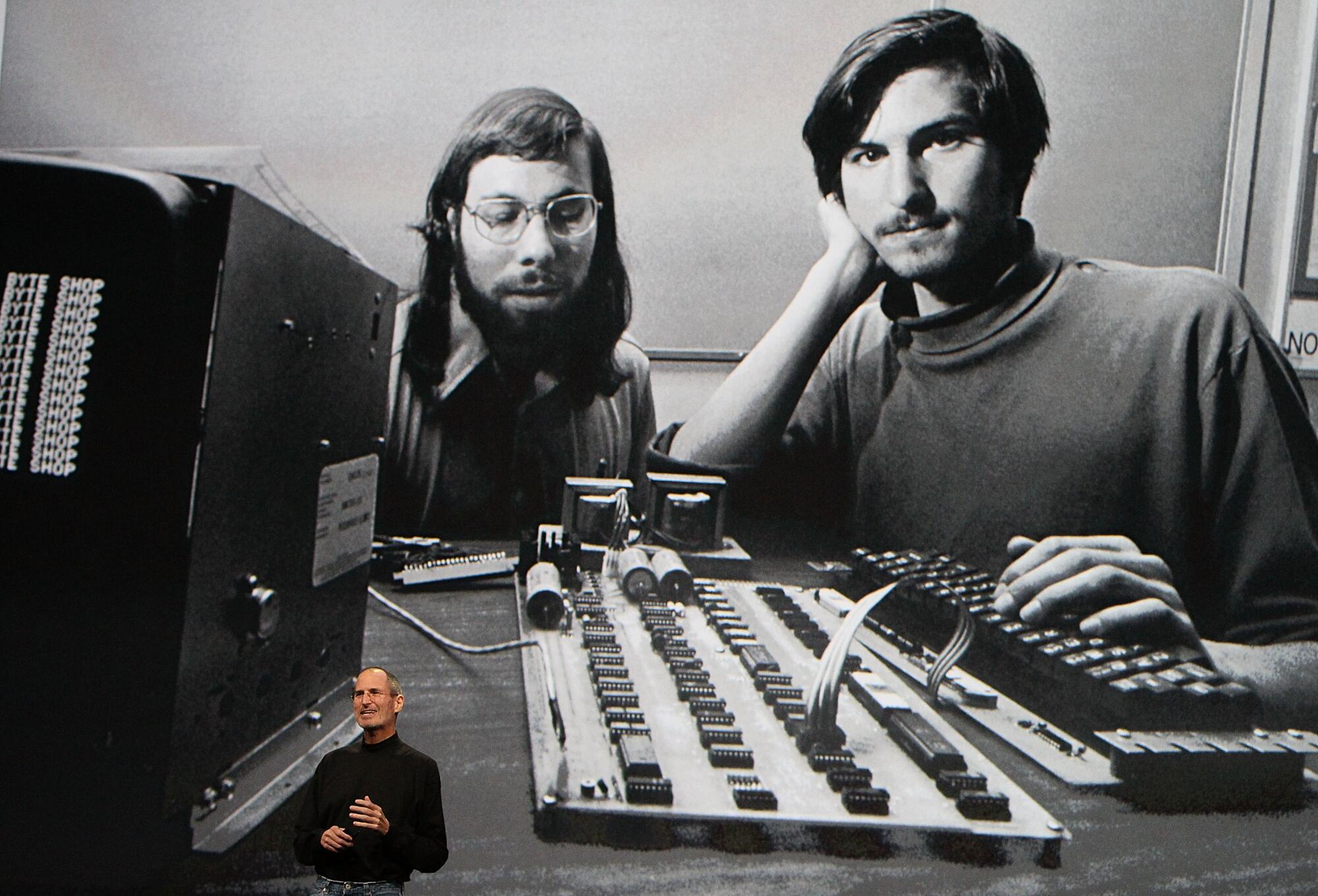 Apple Inc. CEO Steve Jobs speaks during an Apple Special Event in front of an early image of himself and Steve Wozniak 