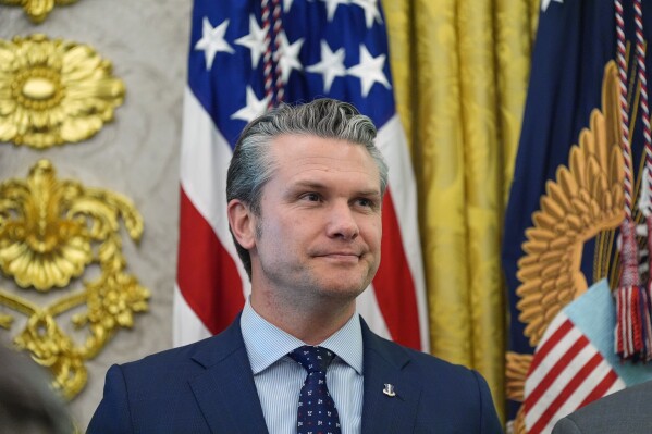 Defense Secretary Pete Hegseth listens as President Donald Trump speaks in the Oval Office of the White House, March 24, 2026, in Washington. (AP Photo/Alex Brandon, File)