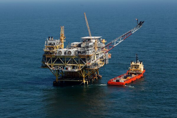 A supply vessel boat sits near an oil rig in the Gulf of Mexico, off the coast of Louisiana. April 10, 2011. (AP Photo/Gerald Herbert, File)