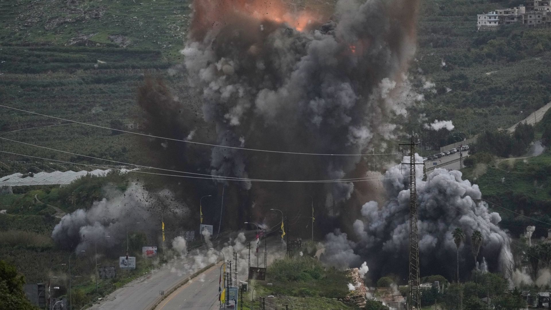 Smoke and flames rise from an Israeli airstrike that hit the Qasmiyeh Bridge near the coastal city of Tyre, Lebanon, Sunday, March 22, 2026.