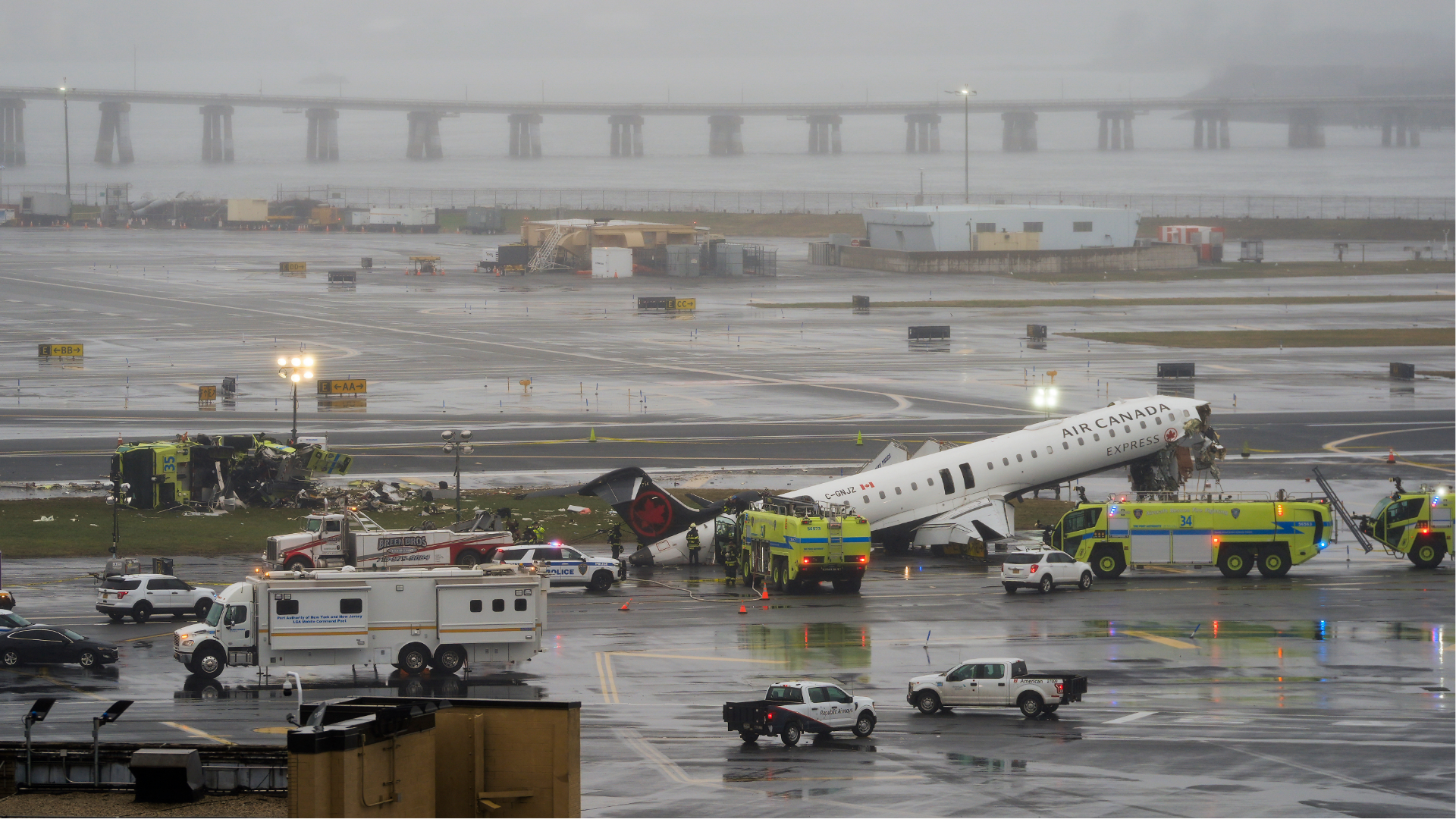 An Air Canada jet and Port Authority fire truck sit on the runway at LaGuardia Airport, Monday, March 23, 2026, after colliding with each other after the Jet landed Sunday night in New York.