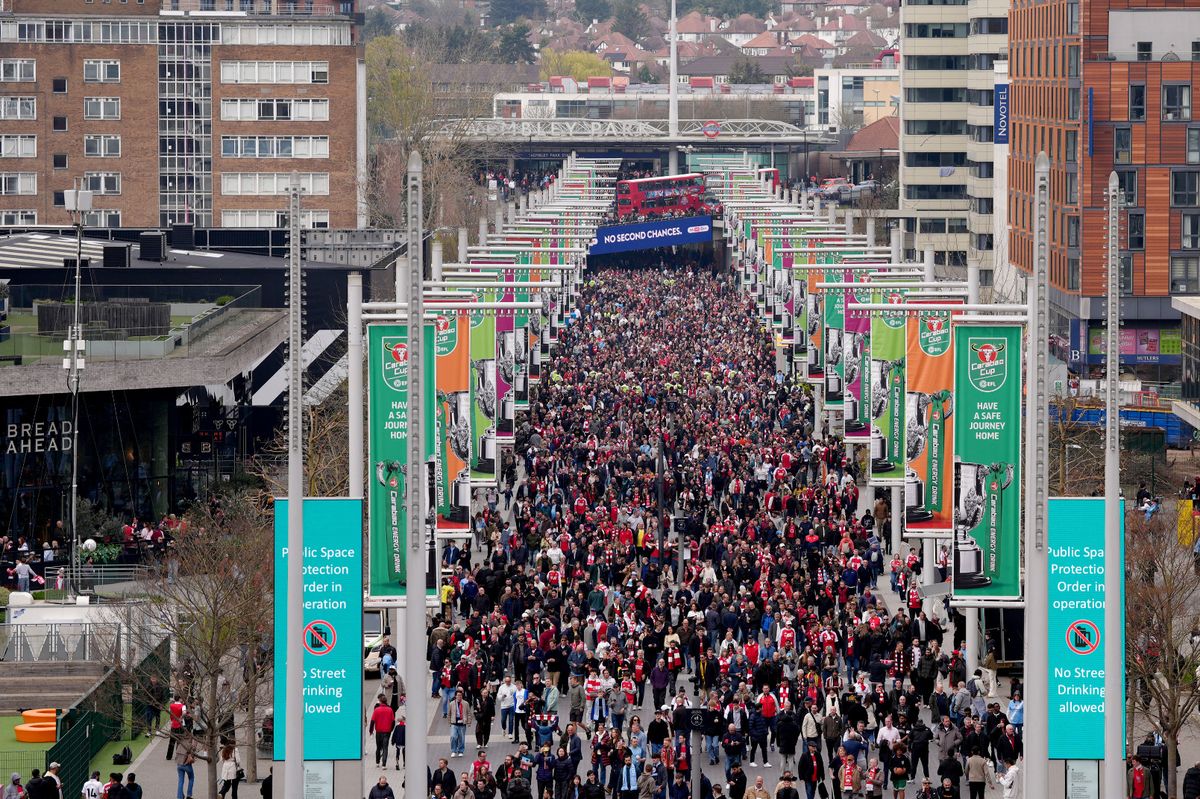 Fans arrive at the ground ahead of the ground ahead of  the Carabao Cup Final at Wembley Stadium