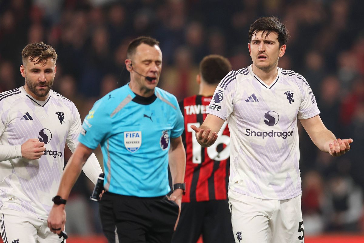 Harry Maguire gestures after being sent off by Stuart Attwell