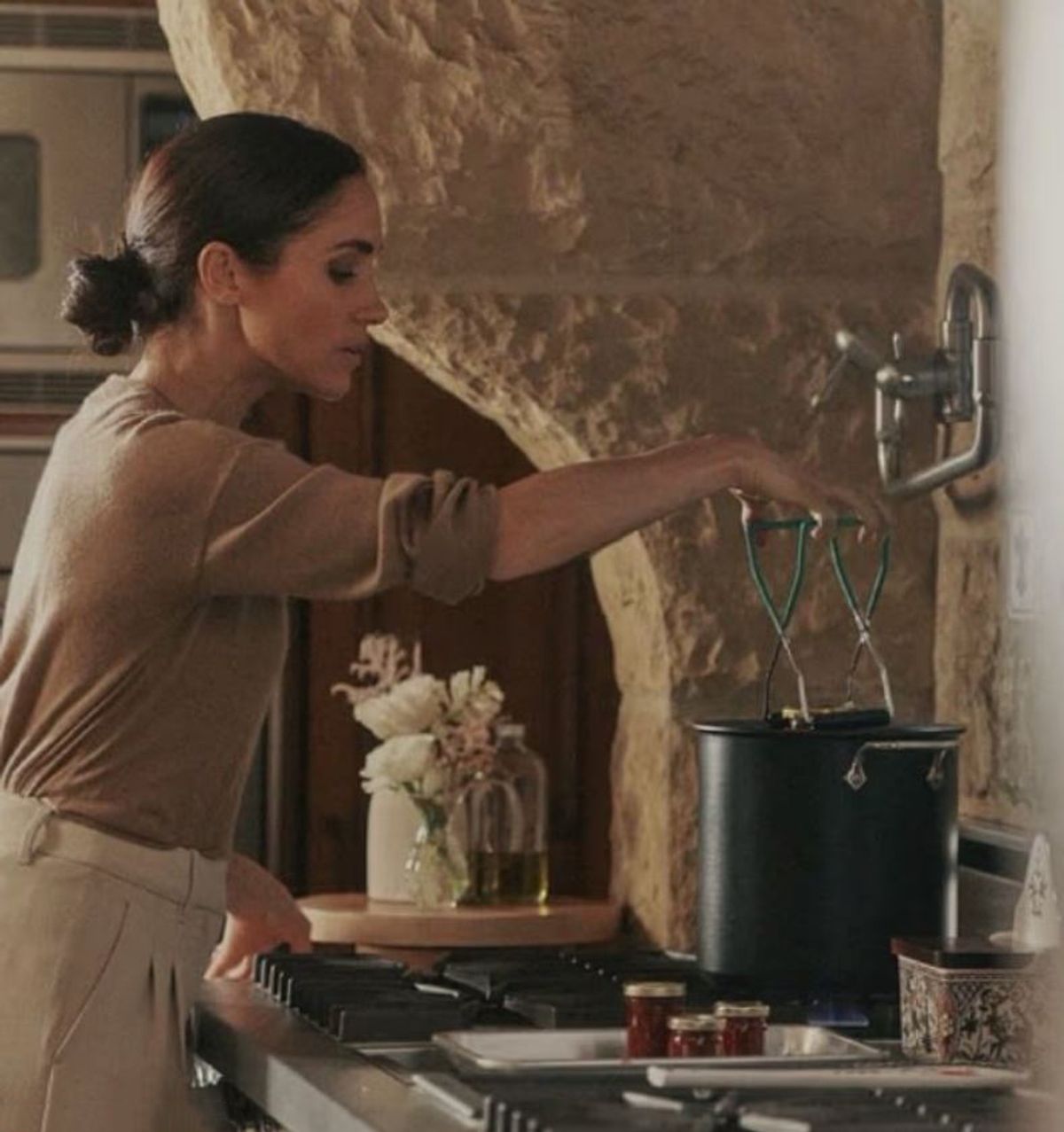 Meghan Markle making jam in a kitchen