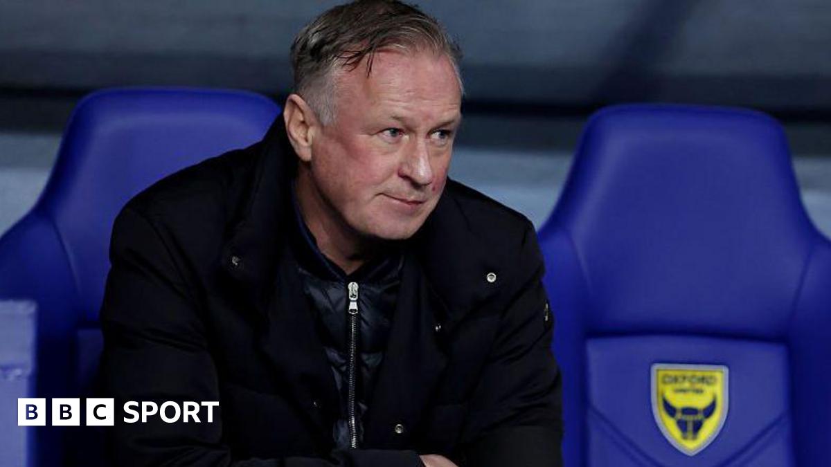 Blackburn Rovers boss Michael O'Neill sits in the Oxford United dugout at the Kassam Stadium