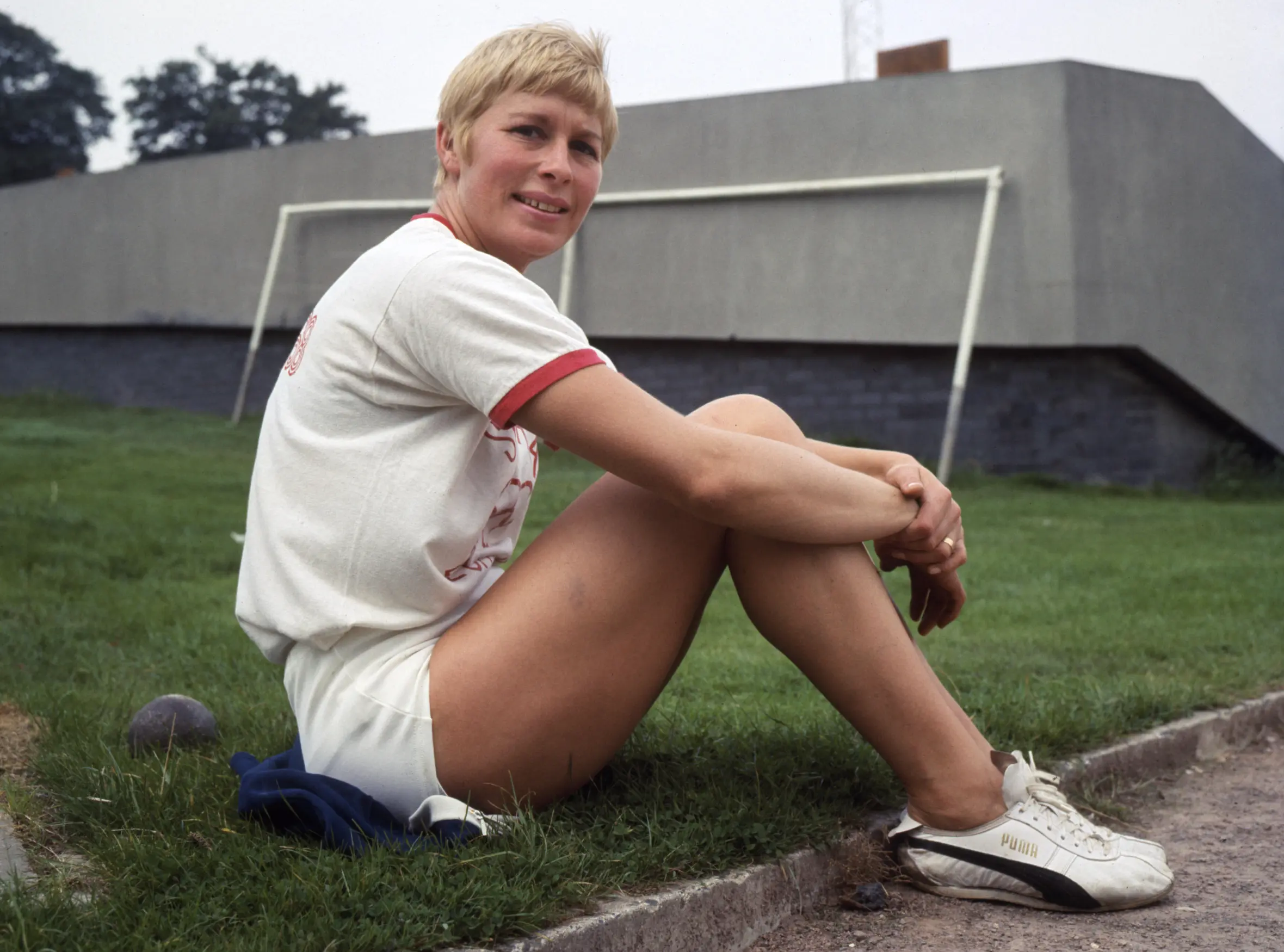 Mary Rand sitting on the grass during a training session.