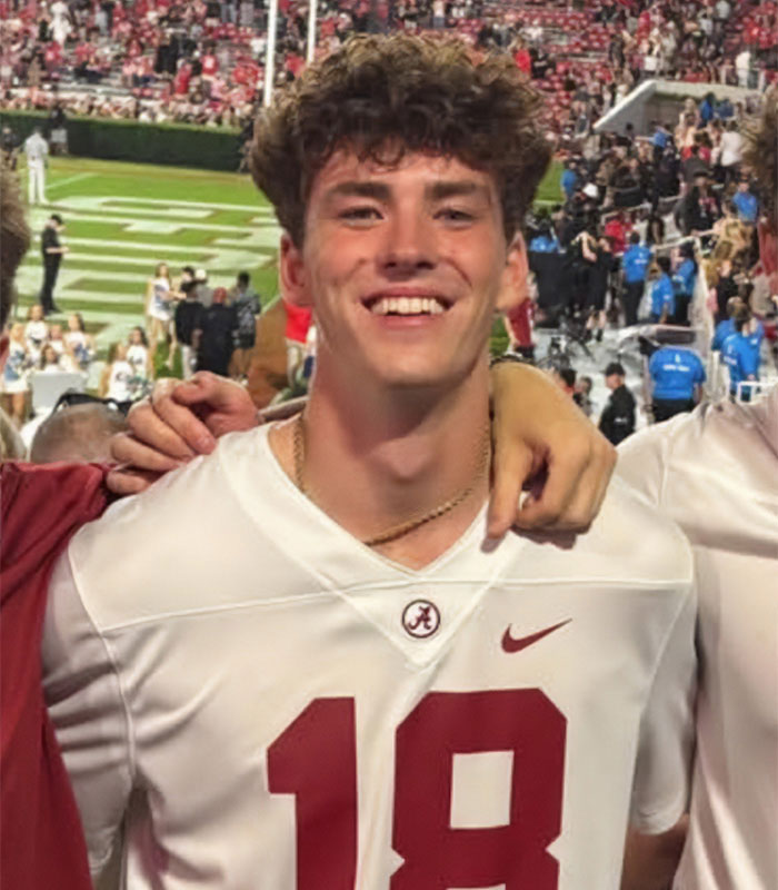 Young Alabama student wearing number 18 jersey at a crowded sports stadium showing harrowing final moments. Young Alabama student wearing number 18 jersey at a crowded sports stadium showing harrowing final moments.
