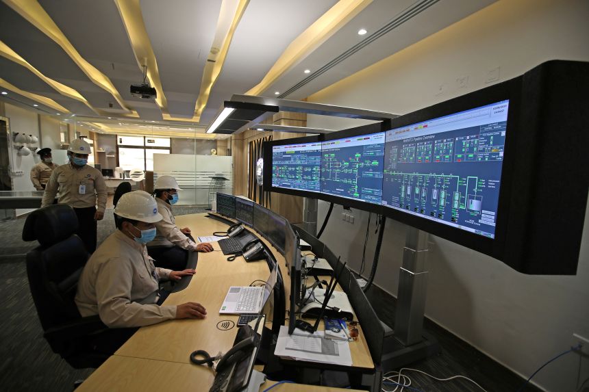Employees work in the pipeline control room of the Saline Water Conversion Corporation in Ras al-Khair, Saudi Arabia, in October 2020.