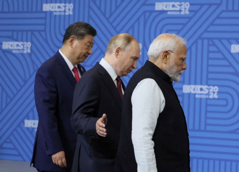 Chinese President Xi Jinping, Russian President Vladimir Putin and Indian Prime Minister Narendra Modi enter a hall for the family photo before a plenary session of the BRICS 2024 Summit in Kazan, Russia, 23 October 2024. MAXIM SHIPENKOV/Pool via REUTERS REFILE - QUALITY REPEAT TPX IMAGES OF THE DAY