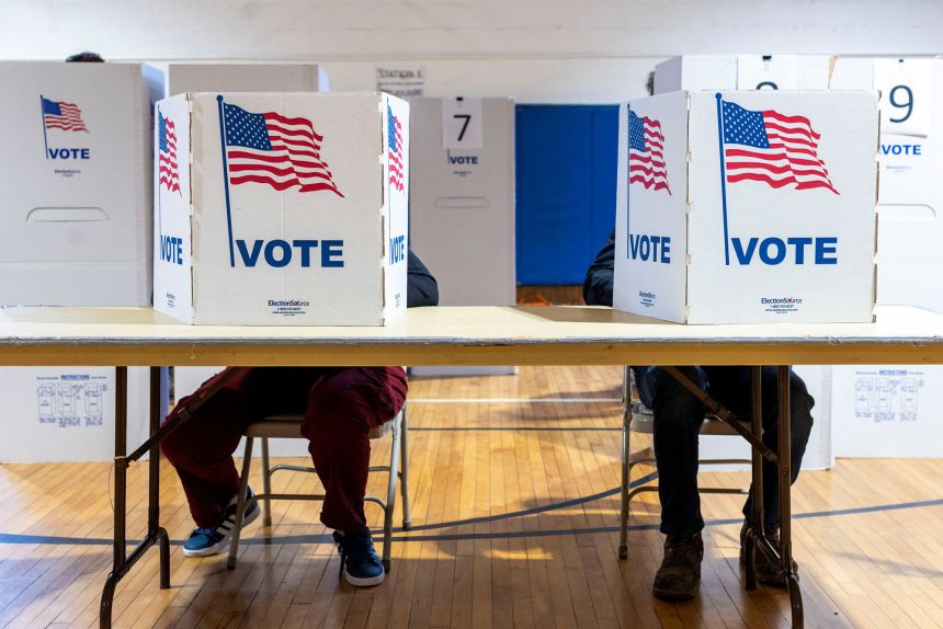 People cast their early ballots on the last day of early voting in Michigan at a polling station in Lansing, Michigan, on November 3, 2024.