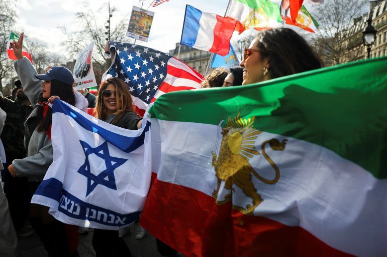 People attend a demonstration with Israeli, American and Iranian flags in support of the Iranian people and to demand the end of the Islamic Republic of Iran after the U.S. and Israel launched strikes on Iran, in Paris, France, March 1, 2026. REUTERS/Sarah Meyssonnier