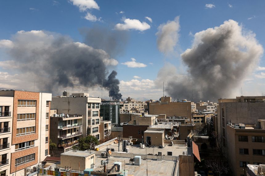 Smoke rises after Israel and the US launched strikes on Tehran on Sunday.