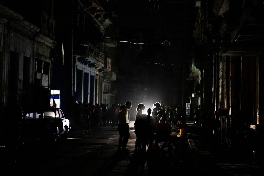 People stand on the street during a mass blackout in Havana, Cuba, on March 4.