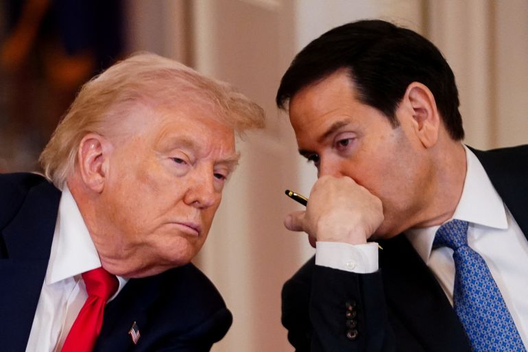 U.S. President Donald Trump listens to U.S. Secretary of State Marco Rubio