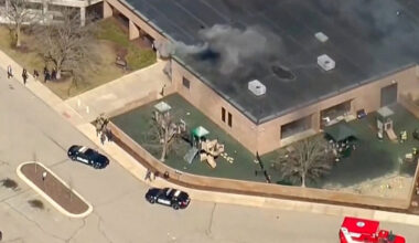 Smoke rises from the building after an active shooting incident was reported at the Temple Israel Synagogue in West Bloomf...