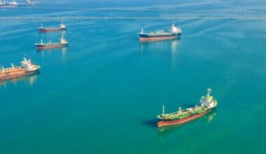Tankers float offshore, representing the oil that the U.S. is now waivering.