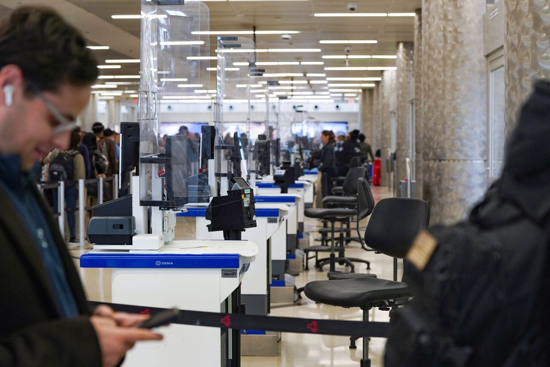 TSA counters sit empty as passengers wait in long security lines at Hartsfield-Jackson Atlanta International Airport on Friday.