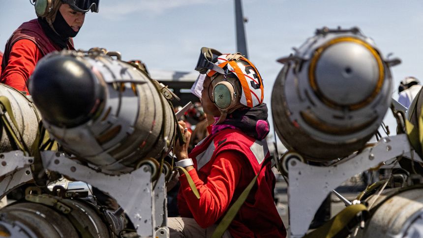 U.S. Navy sailors, assigned to Strike Fighter Squadron 31, conduct a routine ordnance inspection on the flight deck of the USS Gerald R. Ford at an undisclosed location March 17.