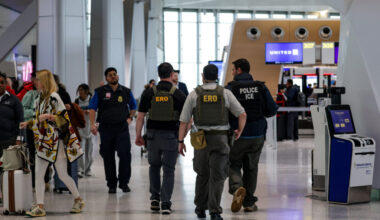 Immigration and Customs Enforcement agents walk at Newark Liberty International Airport