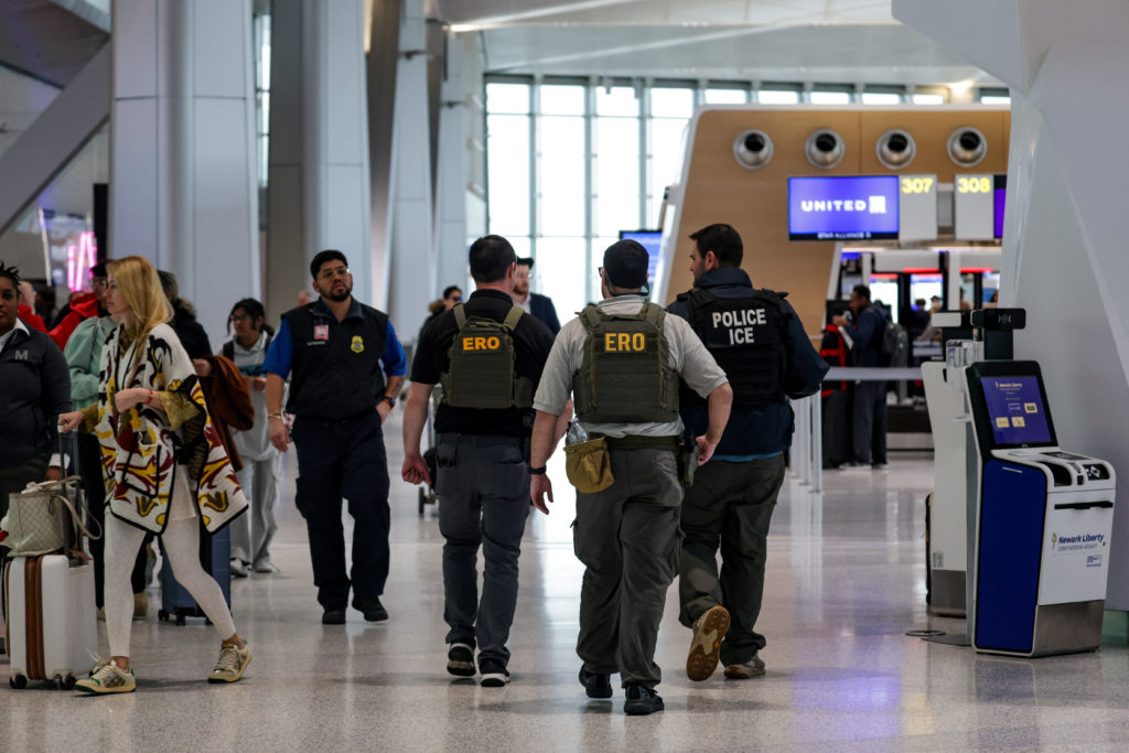Immigration and Customs Enforcement agents walk at Newark Liberty International Airport