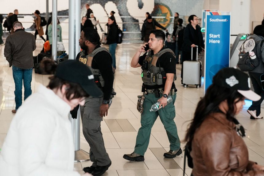 Immigration and Customs Enforcement agents patrol at LaGuardia Airport, in New York, on Monday.