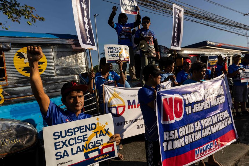 Jeepney drivers stage a rally during their 2-day strike to protest over rising fuel prices in Quezon City, Philippines.